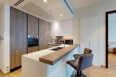 a kitchen with a counter and a chair in a room at Citihome - Luxury 1BR Dubai Marina in Dubai