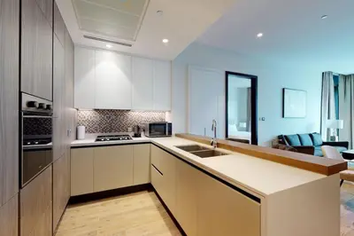 a kitchen with white cabinets and a sink at Citihome - Luxury 1BR Dubai Marina in Dubai