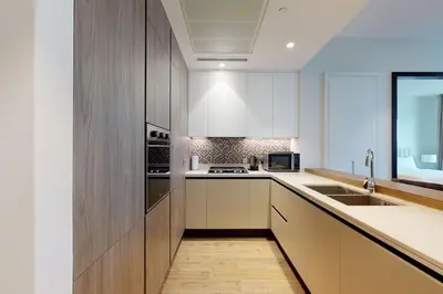a kitchen with white cabinets and a sink at Citihome - Luxury 1BR Dubai Marina in Dubai