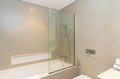 a bathroom with a shower with a glass door at CitiHome Modern and Cozy Prime Location in Dubai