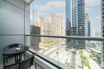 a balcony with a table and a view of a city at Upgraded Bay Central 1 Bed - Marina and Pool View in Dubai