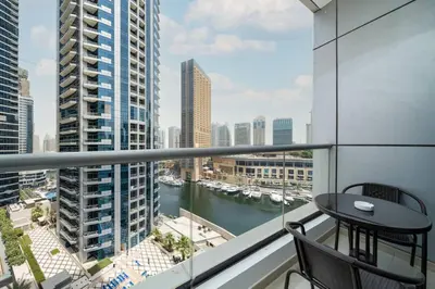 a balcony with a table and a view of a river at Upgraded Bay Central 1 Bed - Marina and Pool View in Dubai