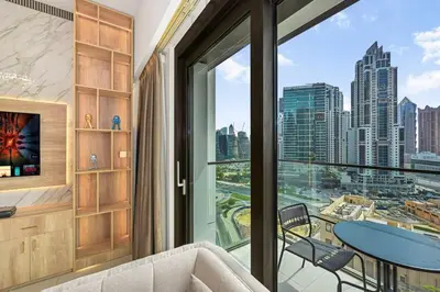 a living room with a large window with a view of the city at 1BR Stay in Burj Crown, Dubai in Dubai