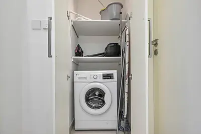 a washer and dryer in a small room at 1BR Stay in Burj Crown, Dubai in Dubai