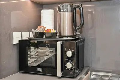 a microwave with a coffee pot on top of it at 1BR Stay in Burj Crown, Dubai in Dubai