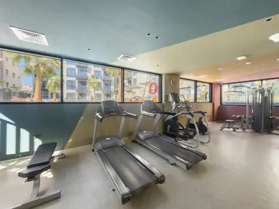 a gym with treadmills and ellipticals in a building at VayK - Contemporary and Cozy Studio in JVC in Dubai