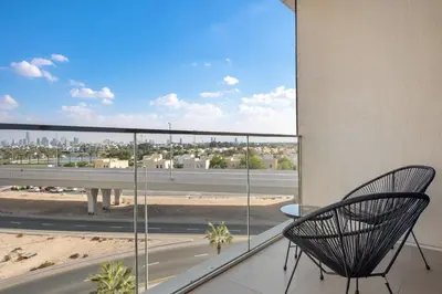 a chair on a balcony with a view of a highway at VayK - Luxurious 1BR in JLT with Premium Amenities in Dubai