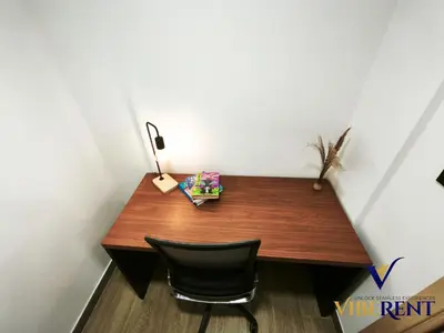 a wooden desk in a room with a chair at Luxury 1BHK Pool Paddle Sauna in Dubai