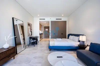 a bedroom with a bed and a living room at Iconic Burj Khalifa View- Aspin Studio in Dubai