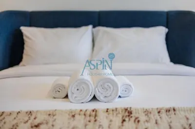 a pile of rolled up towels on a bed at Iconic Burj Khalifa View- Aspin Studio in Dubai