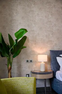 a bedroom with a couch and a table with a lamp at Sobha Hartland Greens 2BR near Dubai Mall in Dubai