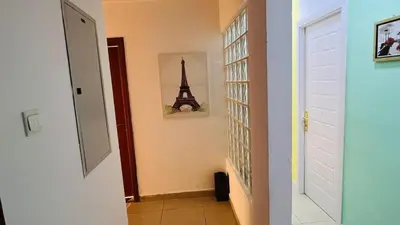 a hallway with a room with a picture of the eiffel tower at City Edge Room In Barsha Heights Tecom in Dubai