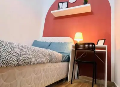 a bedroom with a bed and a desk with a chair at City Edge Room In Barsha Heights Tecom in Dubai