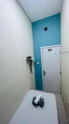 a room with a white table and a blue wall at Comfort Corner In Al Barsha 1 near Mall of Emirates in Dubai