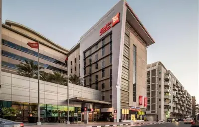 a large building on a city street with at Solo Comfort Corner In Barsha 1 in Dubai