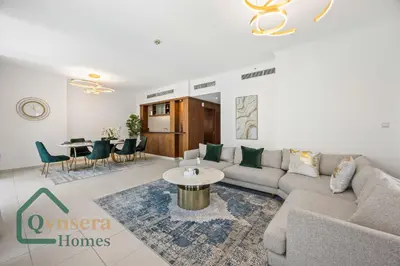a living room with a couch and a table at Iconic Burj & Fountain View Retreat! in Dubai