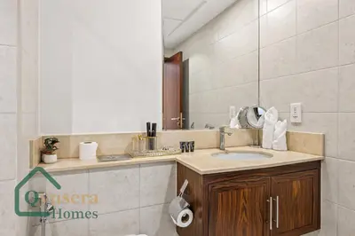 a bathroom with a sink and a mirror at Iconic Burj & Fountain View Retreat! in Dubai