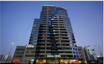 a tall building with a sign on top of it at Dreamstay 2 BR in Business Bay in Dubai