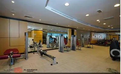 a gym with treadmills and machines in a building at Dreamstay 2 BR in Business Bay in Dubai