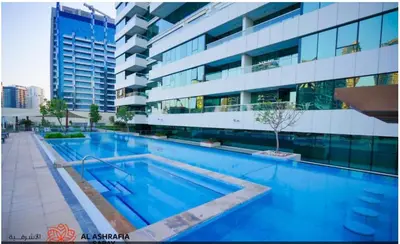 a large swimming pool in front of a building at Dreamstay 2 BR in Business Bay in Dubai