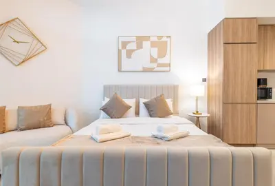 a bedroom with a large bed with two towels on it at Gala Guests - Urban Oasis Apartments Near Burj Khalifa & Downtown Dubai in Dubai