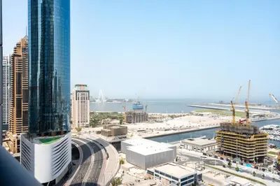 a view of a city with tall buildings and the ocean at Gala Guests - Princess Tower Suites Dubai Marina in Dubai