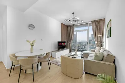 a living room with a table and a couch at Waves - Vibrant and Cozy 1BR Apt in JVC in Dubai