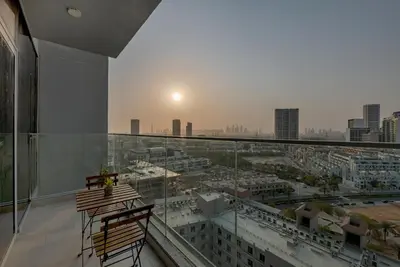 a balcony with a view of a city at Waves - Vibrant and Cozy 1BR Apt in JVC in Dubai
