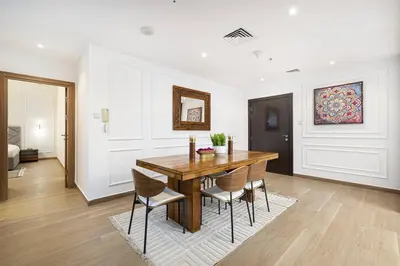 a dining room with a wooden table and chairs at Luxury 2BR w Floating Bed in Dubai Marina Sulafa 4404 in Dubai