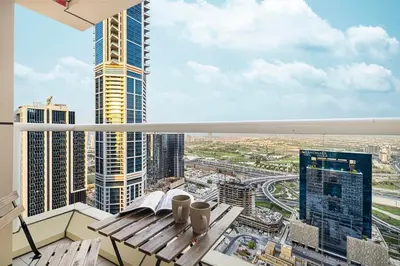 a balcony with a bench and a view of a city at Luxury 2BR w Floating Bed in Dubai Marina Sulafa 4404 in Dubai