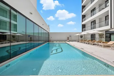 a swimming pool in the middle of a building at Dusk by Binghatti by Rentujemy in Dubai