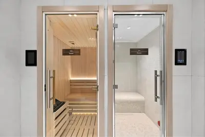 a glass door leading into a walk in shower at Dusk by Binghatti by Rentujemy in Dubai