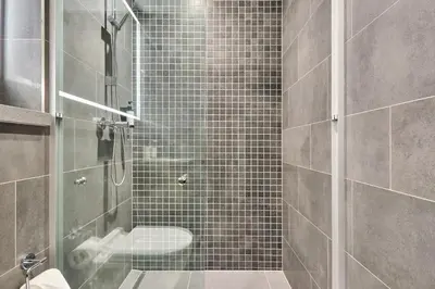 a bathroom with a shower with a toilet and a sink at STAY BY LATINEM Luxury 1BR Holiday Home CB 1414 Near Downtown in Dubai