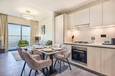 a kitchen and dining room with a table and chairs at STAY BY LATINEM Luxury 1BR Holiday Home CB 1414 Near Downtown in Dubai