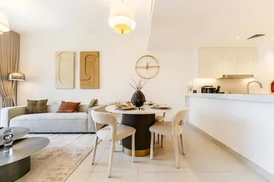 a kitchen and living room with a table and chairs at FAM Living -Madinat Jumeirah Living Apartment with Iconic Views in Dubai