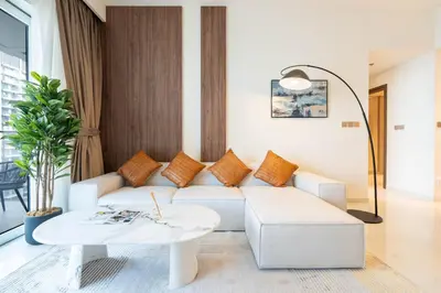 a living room with a white couch and a table at KeyRock - Palm View Apt with Pool & Gym Access in Dubai