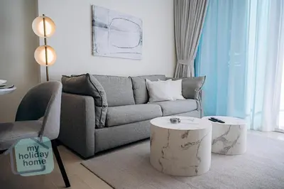 a living room with a couch and a coffee table at Brand New 1BR Fully Furnished in Dubai