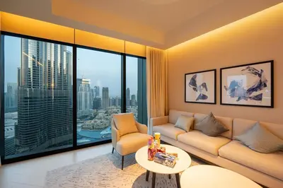 a living room with a couch and a table at Venetian - Sky 3BR - Address Opera with Burj & Fountain views in Dubai