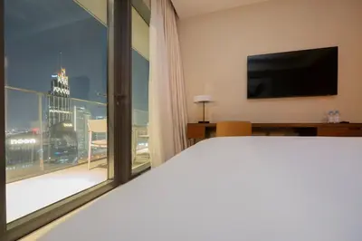 a hotel room with a bed and a large window at Venetian - Sky 3BR - Address Opera with Burj & Fountain views in Dubai