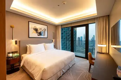 a bedroom with a large bed and a large window at Venetian - Sky 3BR - Address Opera with Burj & Fountain views in Dubai