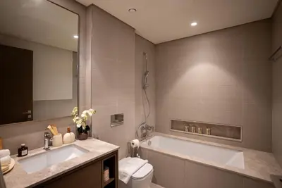 a bathroom with a tub and a toilet and a sink at Grande Downtown Dubai - Luxury 1BR Apt near Burj khalifa and Dubai Mall in Dubai