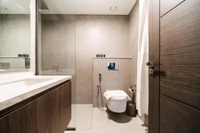a bathroom with a toilet and a sink at SettlerHomes - Lux 20F Stay With Gym, Pool & Cinema in Dubai