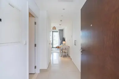 a hallway with a door and a table in a room at RBA Holidays - Luxury Studio near Burj Khalifa - Downtown Dubai in Dubai