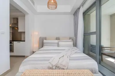 a bedroom with two beds and a large window at RBA Holidays - Luxury Studio near Burj Khalifa - Downtown Dubai in Dubai