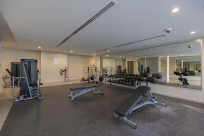a gym with several exercise bikes and a mirror at City View with Balcony Next to Dubai Water Canal, Walking Distance to Marine Transport Station, Easy Downtown Access, Reva Residences, Business Bay by Deluxe Holiday Homes in Dubai