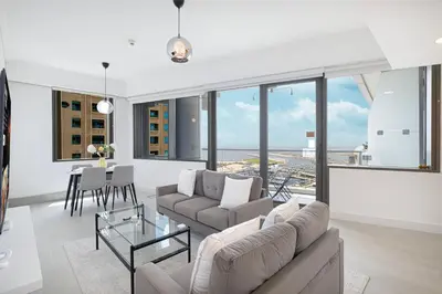 a living room with a couch and a table at Sea & City View Apartment Dubai Marina - Ravello Living in Dubai