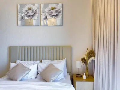 a bedroom with a bed with three pictures on the wall at Luxury Redefined 1BR Apartment in Emaar 5242 in Dubai