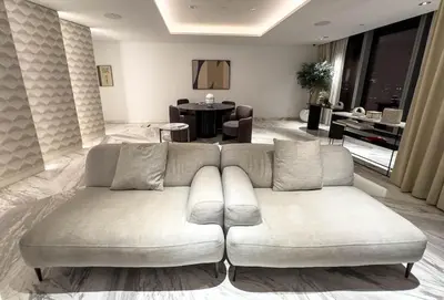 a living room with a couch and a table at Luxury Redefined 1BR Apartment in Emaar 5242 in Dubai