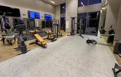 a gym with several treadmills and exercise machines at Luxury Redefined 1BR Apartment in Emaar 5242 in Dubai
