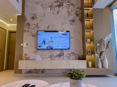 a living room with a television on a wall at Luxury Redefined 1BR Apartment in Emaar 5242 in Dubai